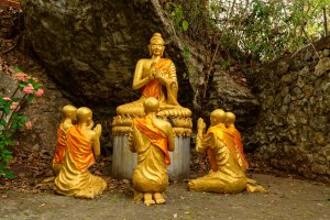 Laos: estatuas doradas de Buda y monjes en el monte Phousi de Luang Prabang