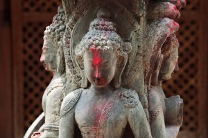 Nepal: antigua deidad hindú de piedra con sindoor rojo en Katmandú
